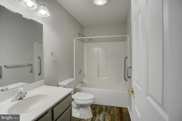 full bathroom with hardwood / wood-style flooring, vanity, tub / shower combination, and toilet