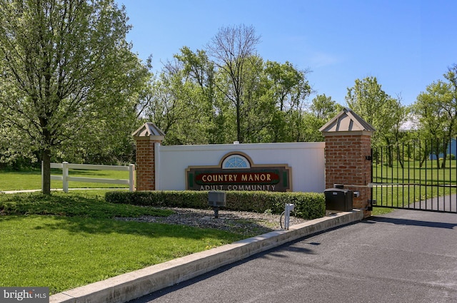 community / neighborhood sign with a lawn