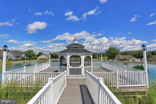 dock area with a gazebo and a water view