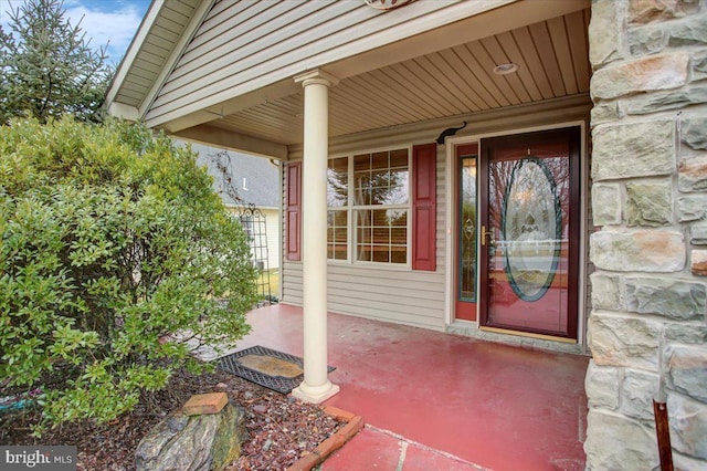 view of exterior entry with a porch