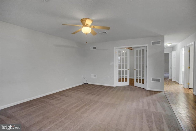 carpeted empty room with french doors and ceiling fan