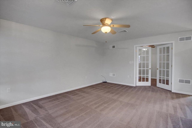 carpeted empty room featuring french doors and ceiling fan