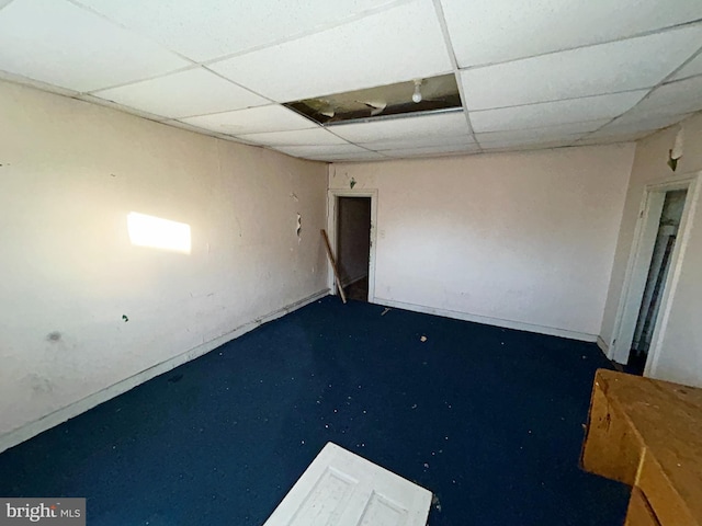 basement with a paneled ceiling