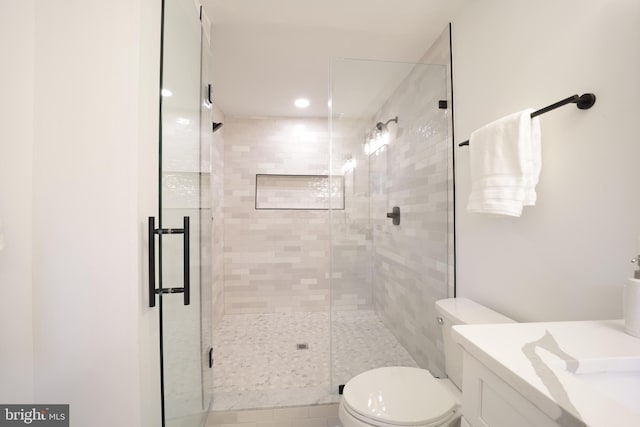 bathroom featuring walk in shower, vanity, and toilet