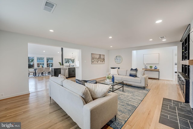 living room with sink and light hardwood / wood-style floors