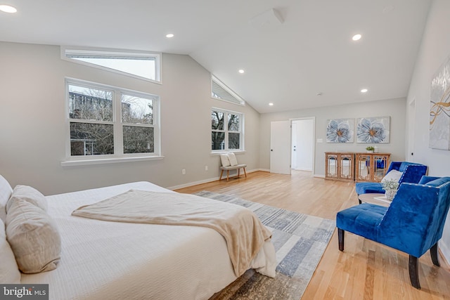 bedroom featuring hardwood / wood-style flooring, lofted ceiling, and multiple windows