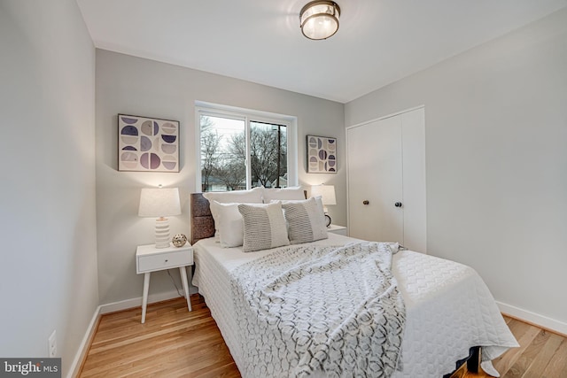 bedroom with hardwood / wood-style floors and a closet