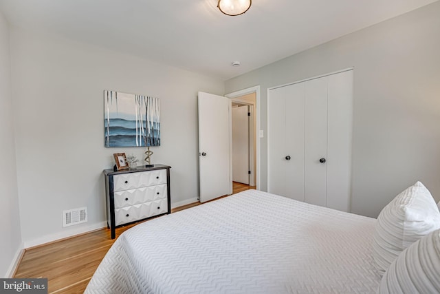 bedroom with light hardwood / wood-style flooring and a closet