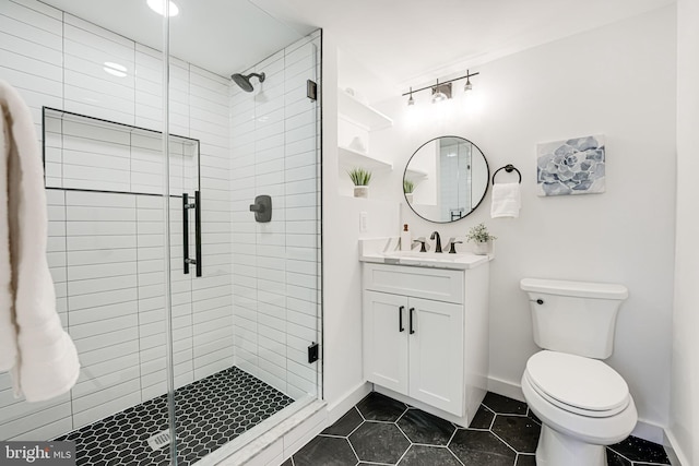 bathroom featuring vanity, walk in shower, tile patterned floors, and toilet