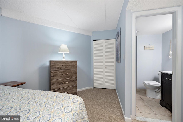 carpeted bedroom with a closet and a textured ceiling