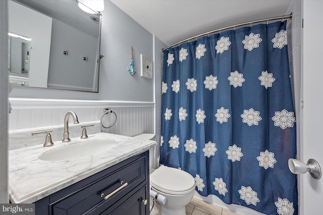 bathroom with tile patterned flooring, vanity, and toilet