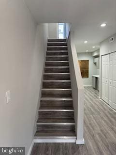 stairway featuring wood-type flooring