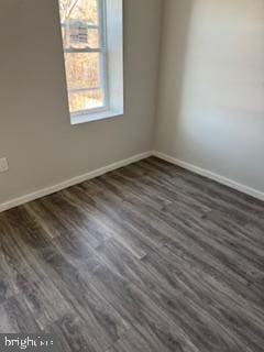 empty room featuring dark wood-type flooring