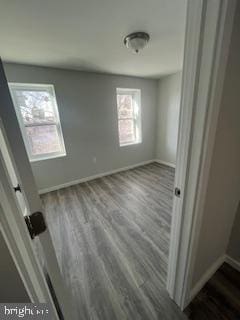 unfurnished bedroom with dark hardwood / wood-style floors