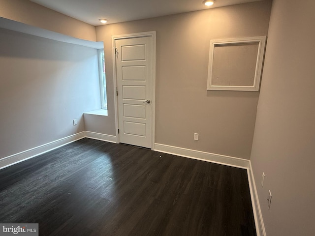 spare room with dark hardwood / wood-style flooring