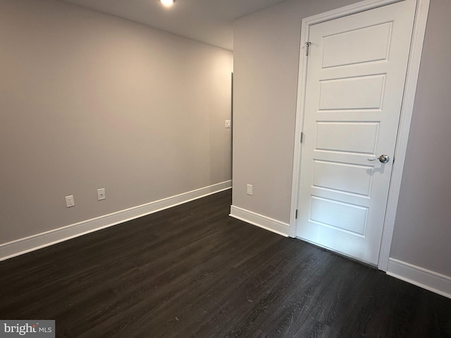 empty room featuring dark hardwood / wood-style flooring