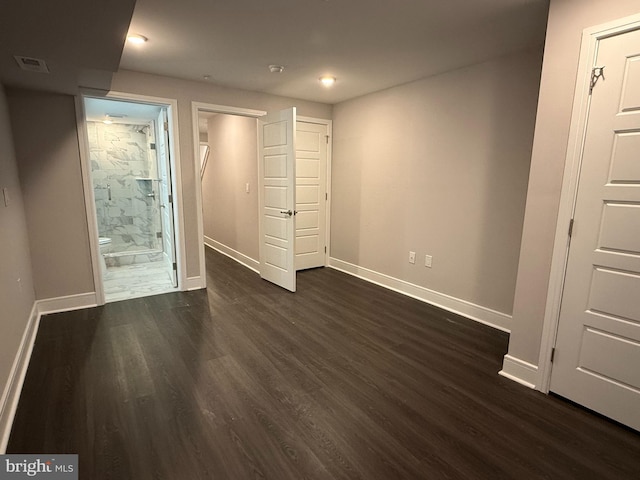 unfurnished room featuring dark wood-type flooring