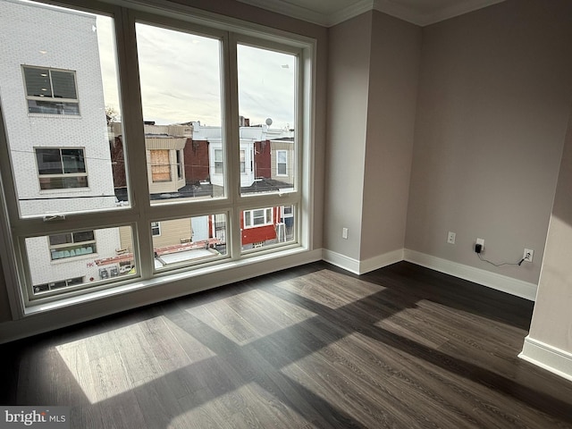 unfurnished room featuring ornamental molding and dark hardwood / wood-style floors