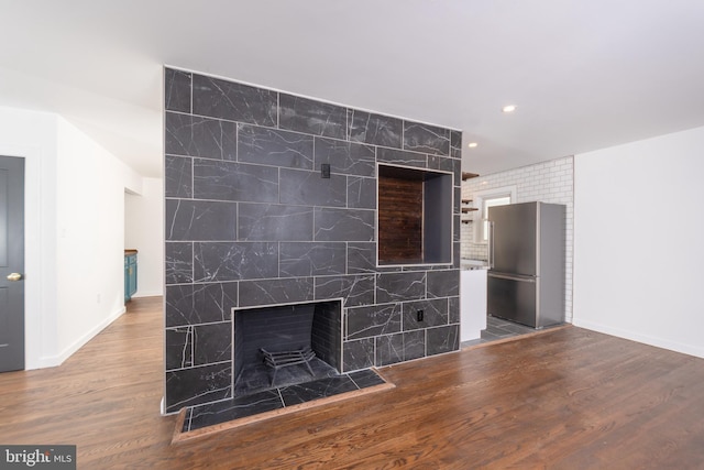 unfurnished living room with hardwood / wood-style floors and a fireplace