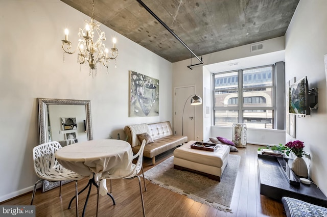 living room featuring hardwood / wood-style flooring and an inviting chandelier