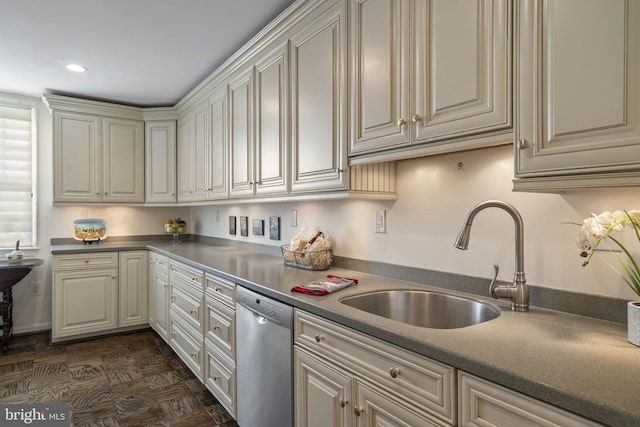 kitchen featuring stainless steel dishwasher, sink, and dark parquet floors