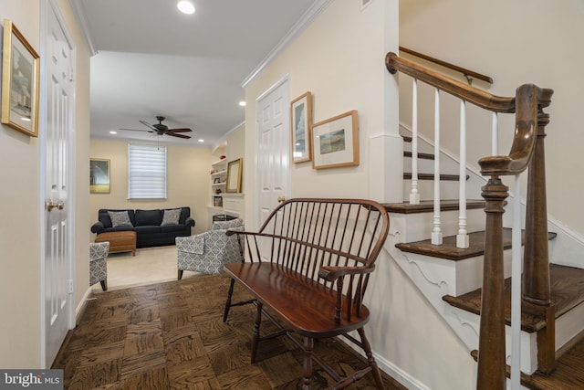 interior space with crown molding, dark parquet flooring, and ceiling fan