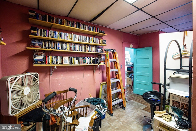 interior space with a paneled ceiling