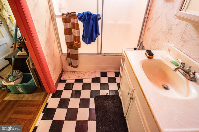 bathroom featuring vanity and bath / shower combo with glass door