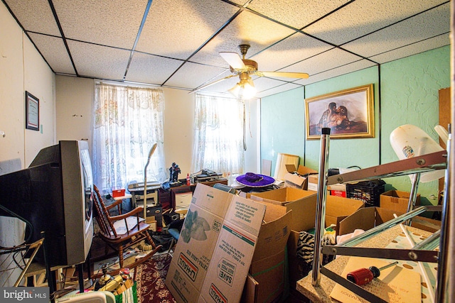 interior space with ceiling fan