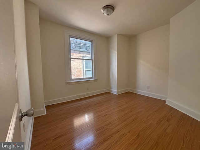 spare room featuring hardwood / wood-style floors