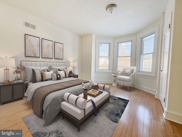 bedroom featuring multiple windows and light wood-type flooring