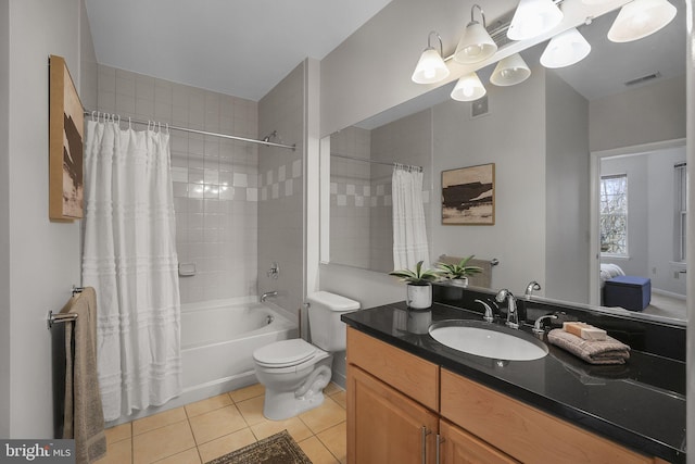 full bath with tile patterned flooring, toilet, vanity, visible vents, and shower / bath combo