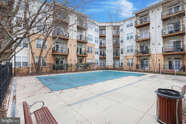 view of swimming pool featuring fence