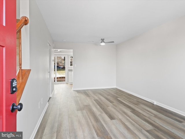 empty room featuring ceiling fan and light hardwood / wood-style floors