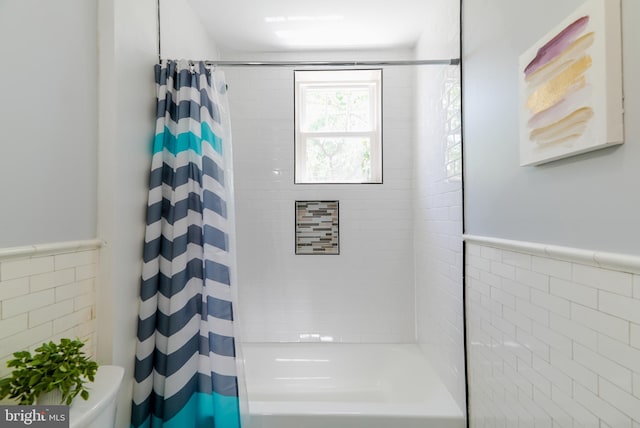 3603 Oakmont Ave, Baltimore, MD 21215 - full bath featuring shower / bathtub combination with curtain, tile walls, toilet, and a wainscoted wall