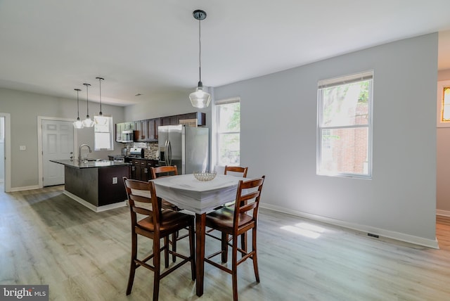 3603 Oakmont Ave, Baltimore, MD 21215 - dining space featuring light wood-style flooring and baseboards