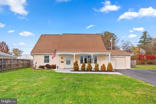 view of front facade featuring a garage, covered porch, and a front lawn