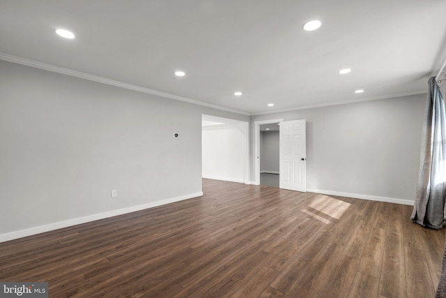 spare room featuring crown molding and dark hardwood / wood-style floors