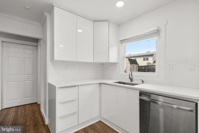 kitchen with dark wood-type flooring, sink, white cabinetry, dishwasher, and decorative backsplash