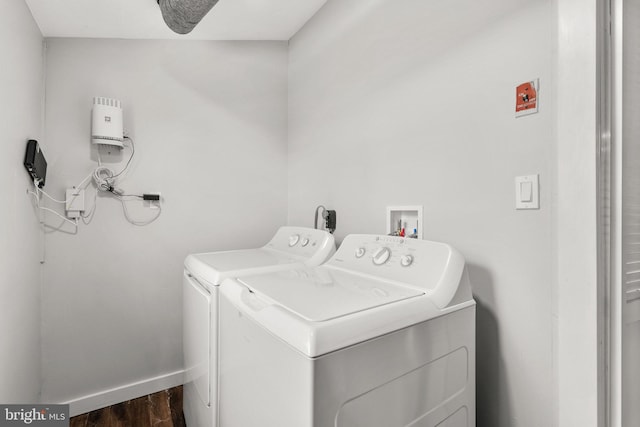 clothes washing area with hardwood / wood-style floors and washer and clothes dryer