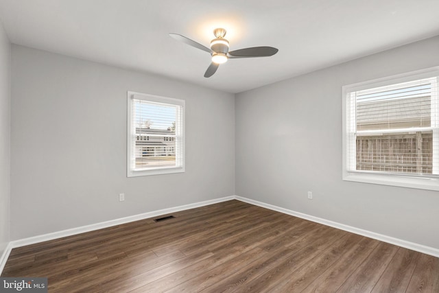 unfurnished room with ceiling fan and dark hardwood / wood-style flooring