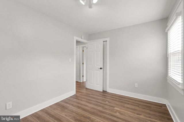 empty room with hardwood / wood-style floors