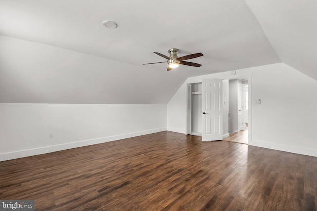 additional living space featuring vaulted ceiling, dark hardwood / wood-style floors, and ceiling fan