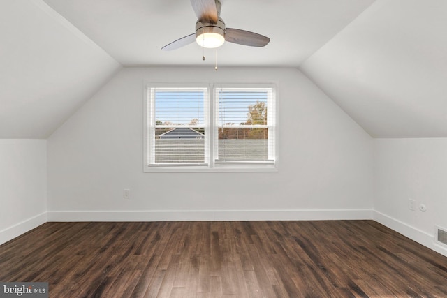 additional living space featuring dark hardwood / wood-style flooring, vaulted ceiling, and ceiling fan