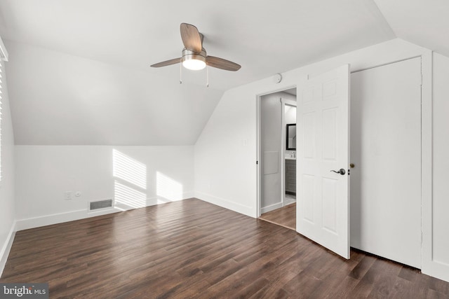 bonus room featuring dark hardwood / wood-style flooring, vaulted ceiling, and ceiling fan