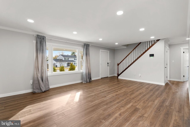 unfurnished living room featuring crown molding and wood-type flooring