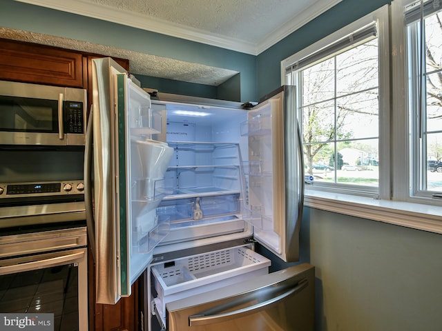 interior space with ornamental molding, oven, and a textured ceiling