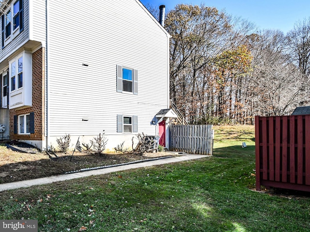 view of home's exterior with a yard