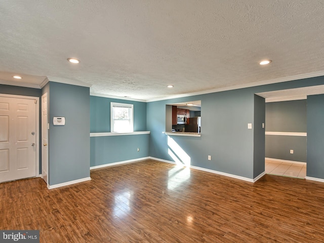 interior space with hardwood / wood-style floors, crown molding, and a textured ceiling