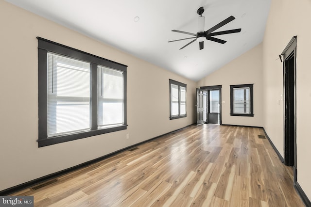 empty room with vaulted ceiling, ceiling fan, and light hardwood / wood-style floors